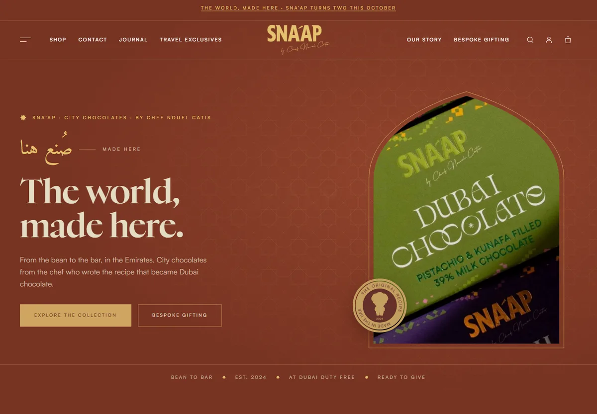 SNA'AP & Co storefront: rust background, the headline The world, made here, and a green Dubai Chocolate box inside an arch